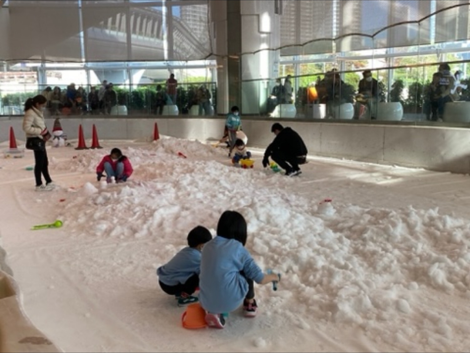 Children playing in snow on the rink